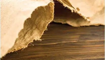 torn parchment paper texture on a wooden surface
