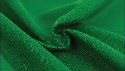 vibrant green fabric texture with soft folds and a central swirl