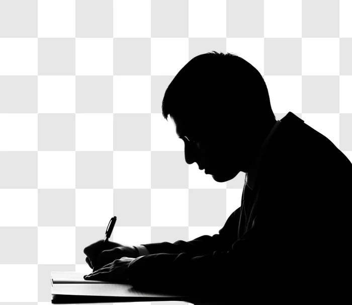 man writing in notebook silhouette against black edited